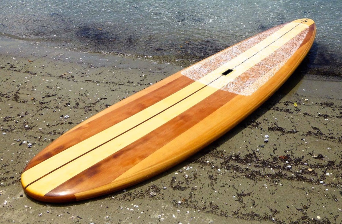 Wooden paddleboard beside the water