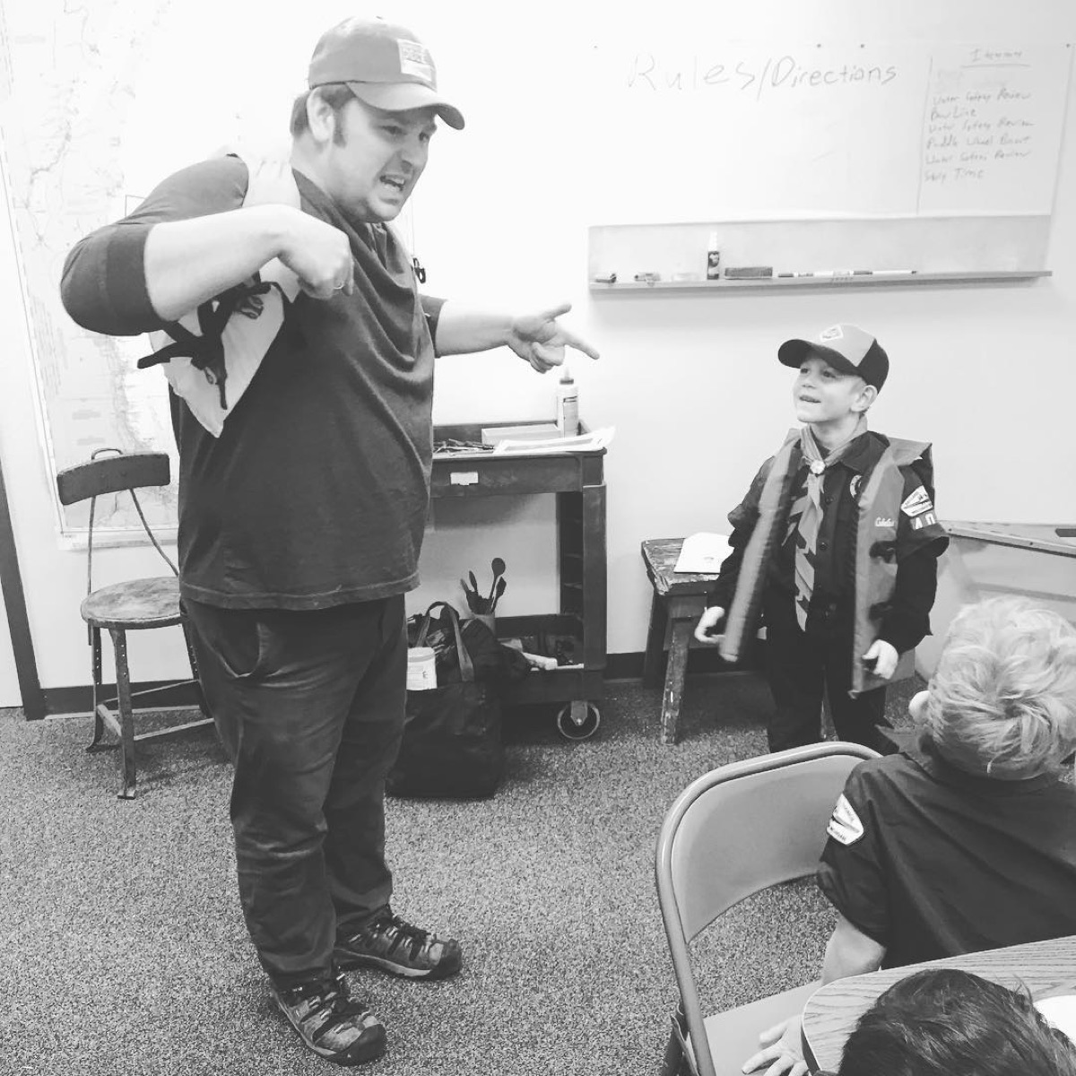 Instructor demonstrating a long woodworking tool