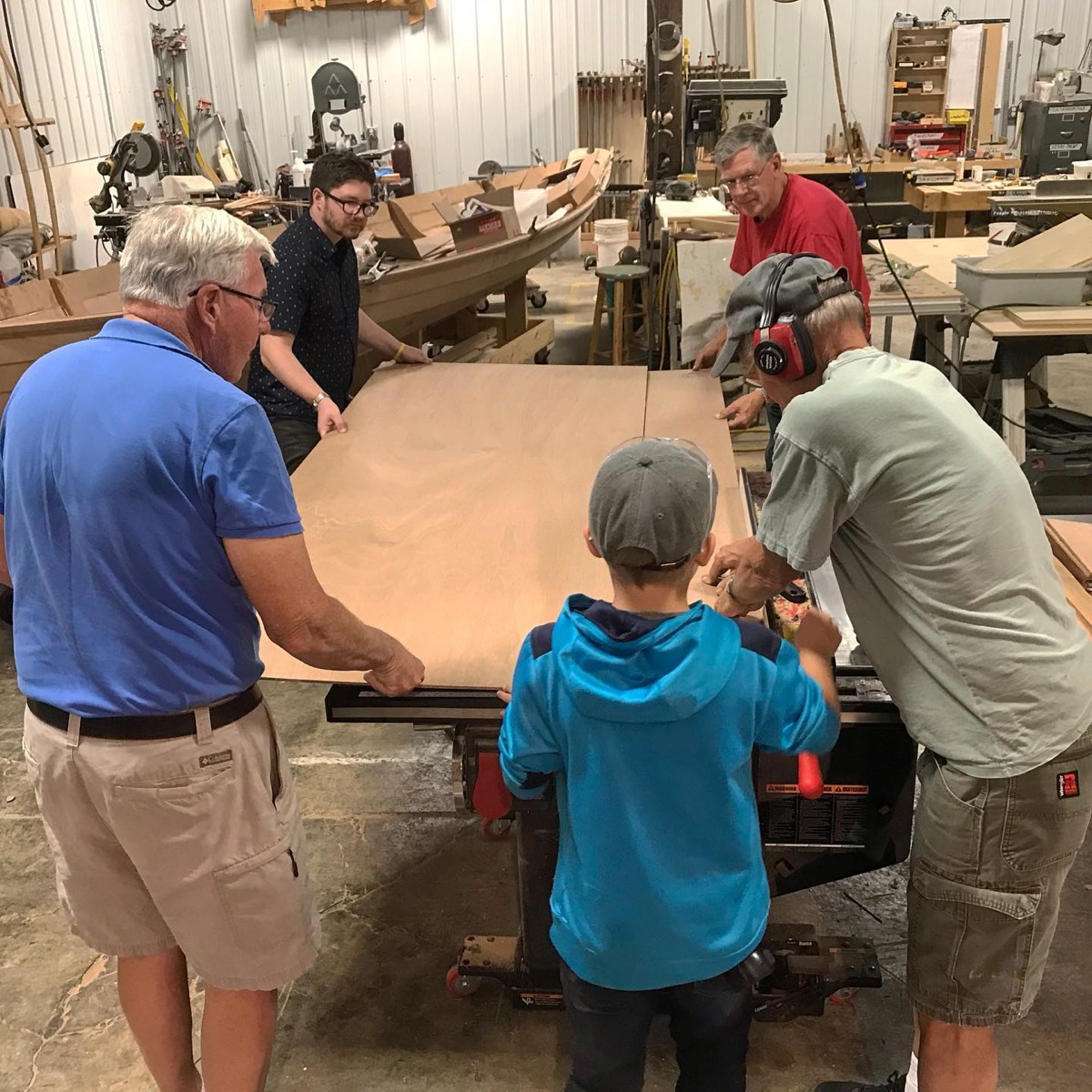 Children and mentors gathered around workbenches