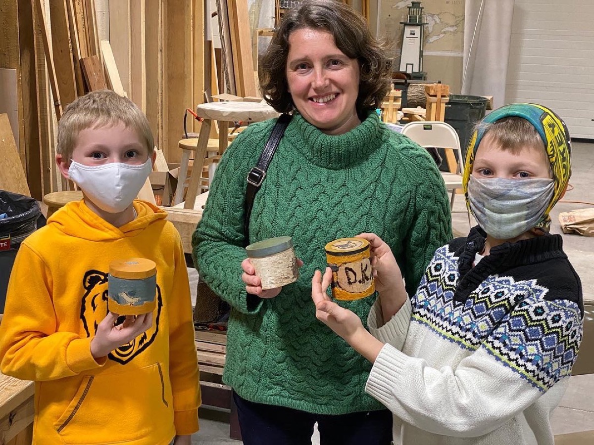 Children and instructor displaying mugs