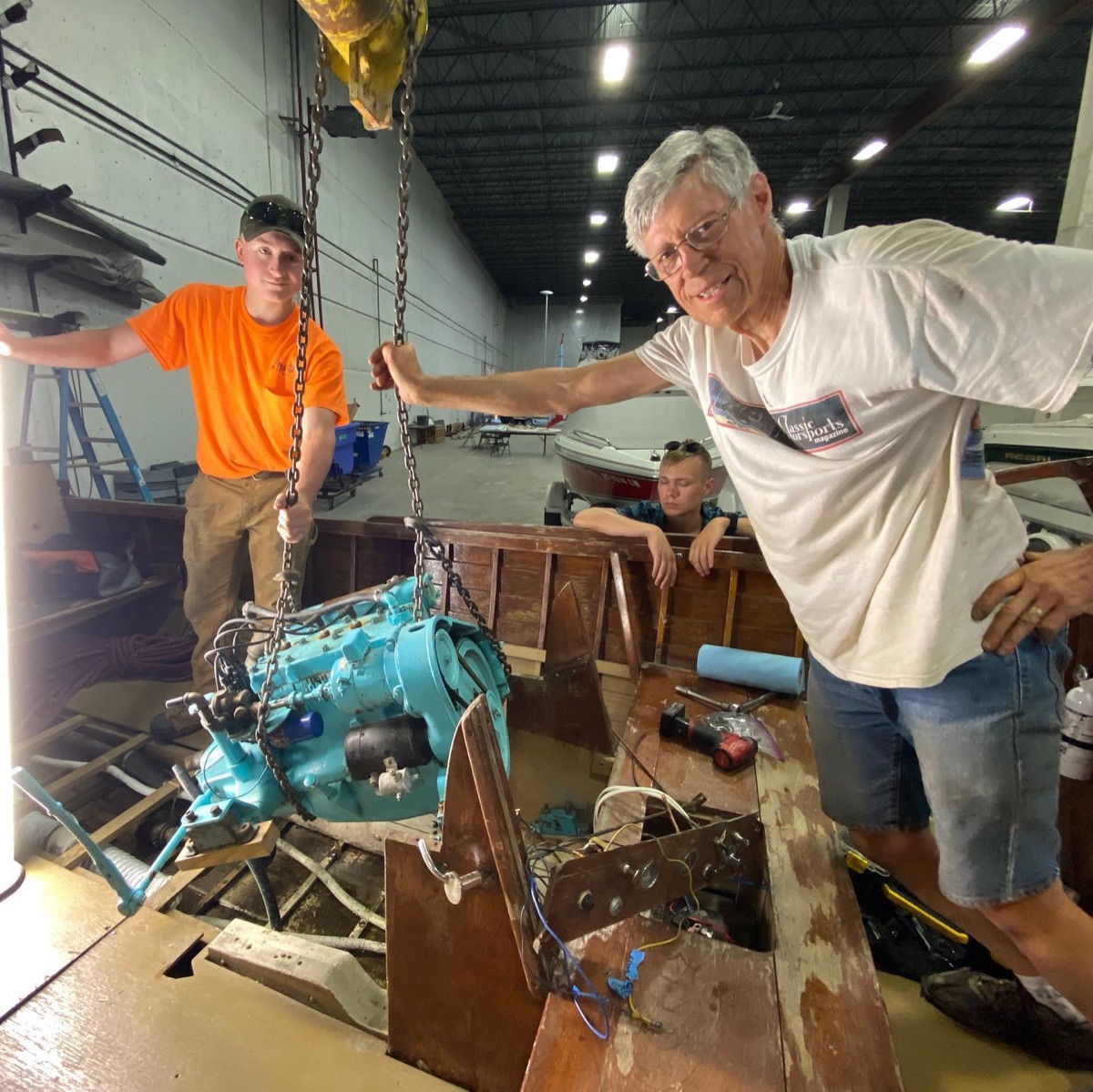 Volunteers maintaining boat machinery