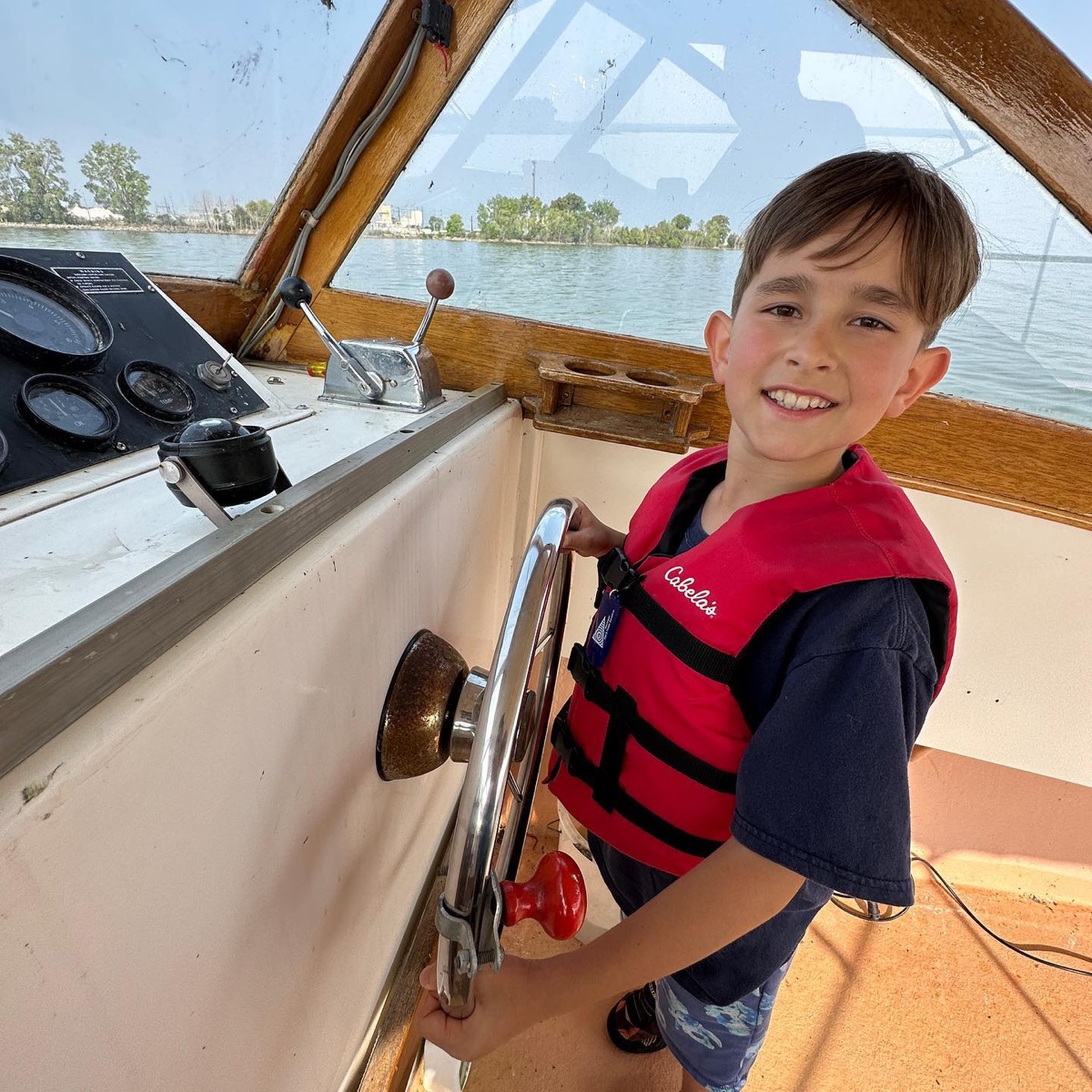 Child at the wheel of a boat