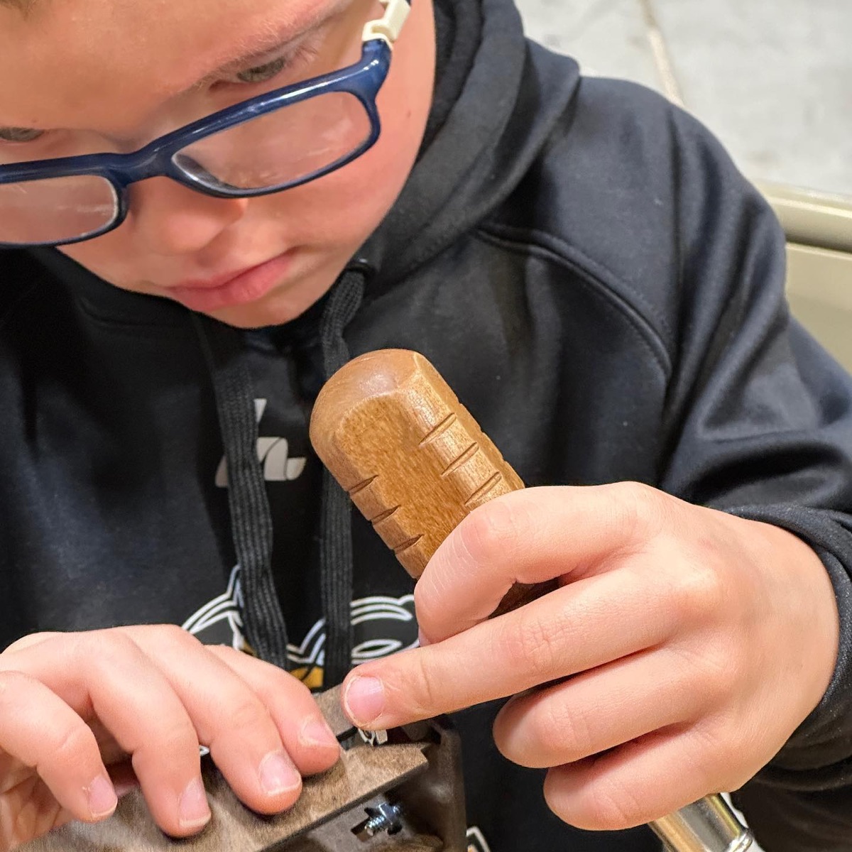 Student using a hand plane close up