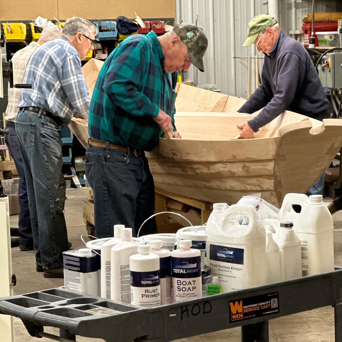 Volunteers building a wooden boat