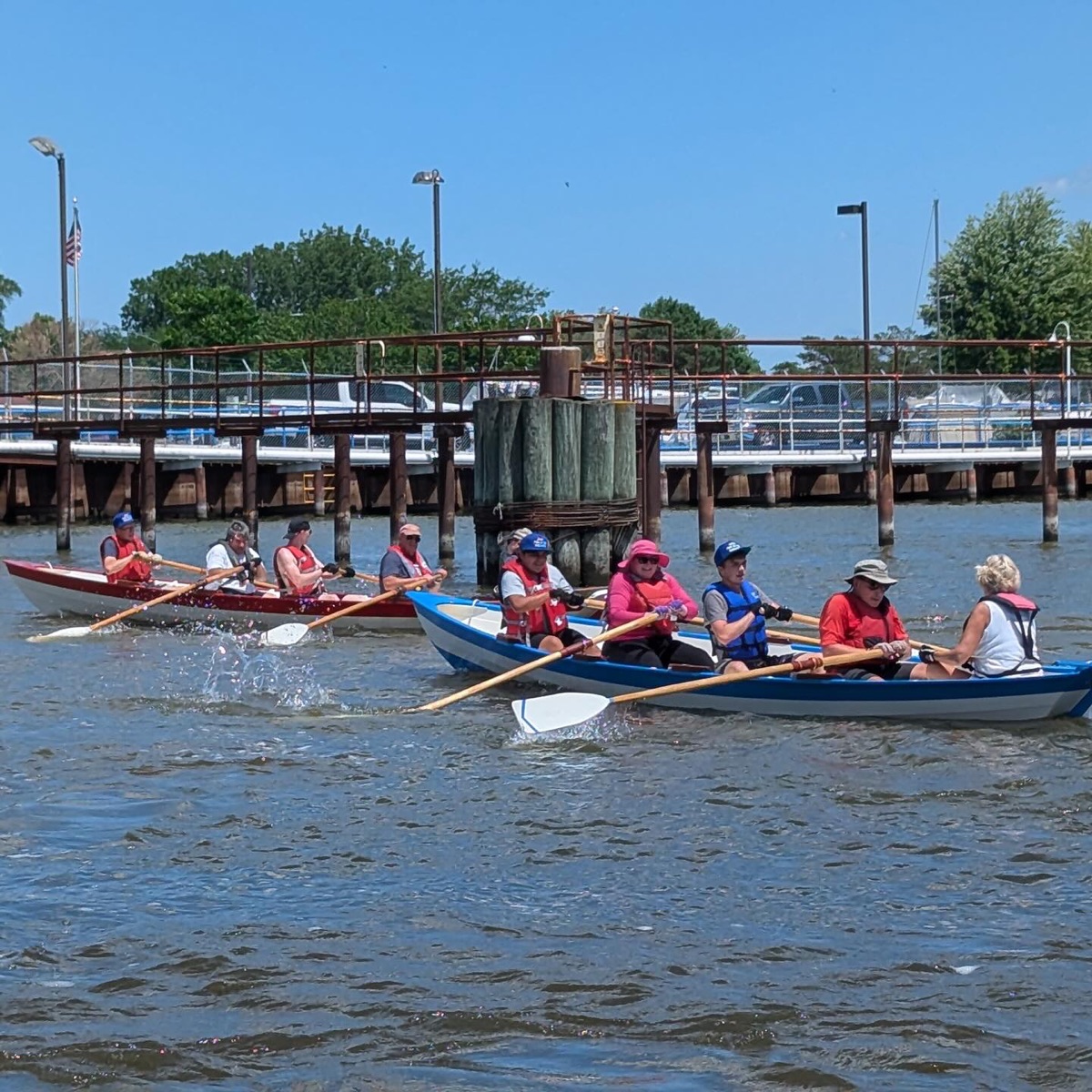 Group paddling boats near a dock