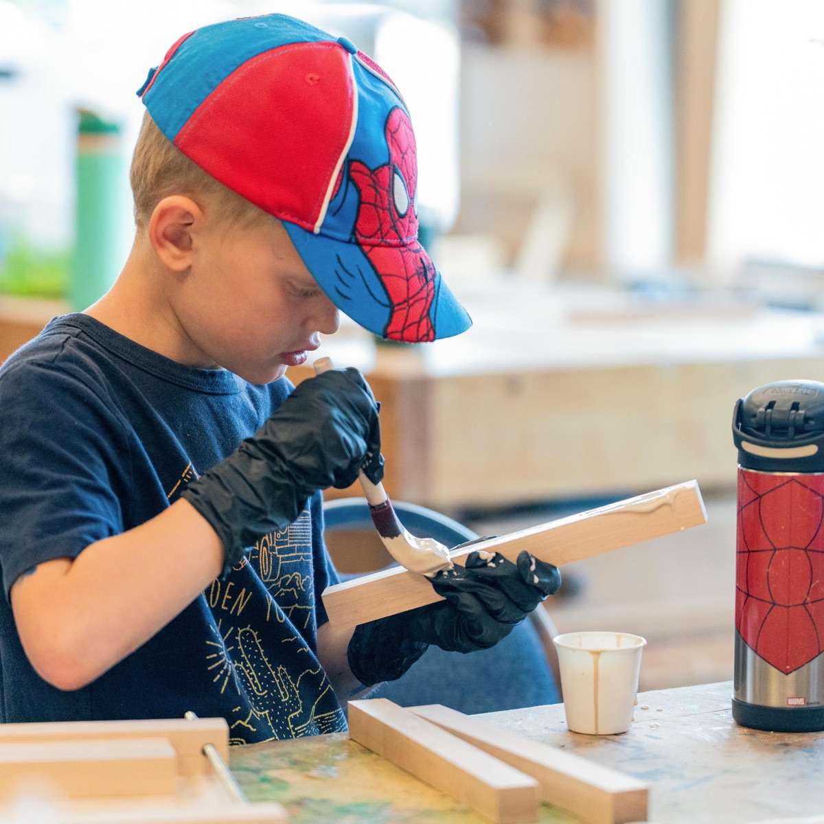Student carving a small wooden project