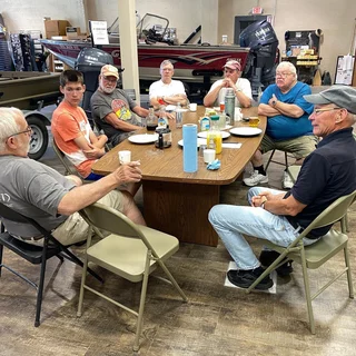 Hands On Deck volunteers gathered around the workshop breakfast table